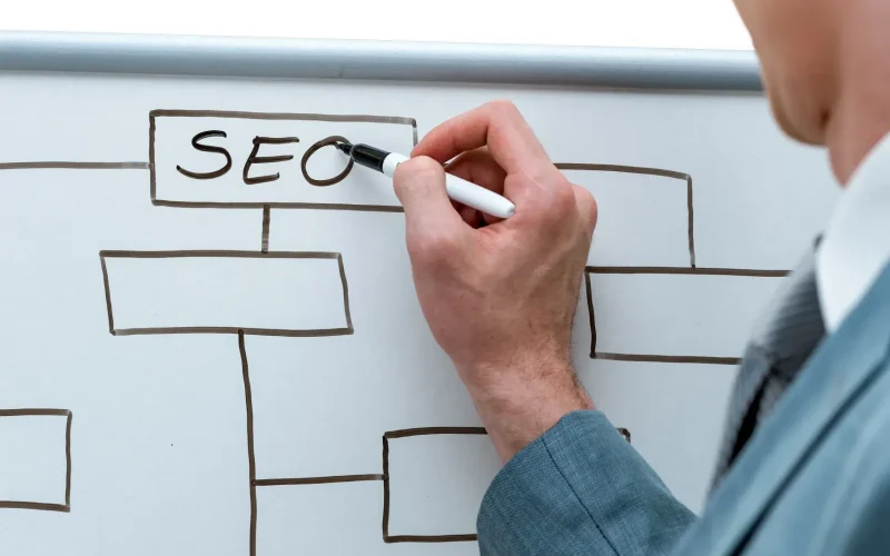 Experto de Sagatech explicando la estrategia de SEO en una pizarra para mejorar el posicionamiento web en Sevilla.
